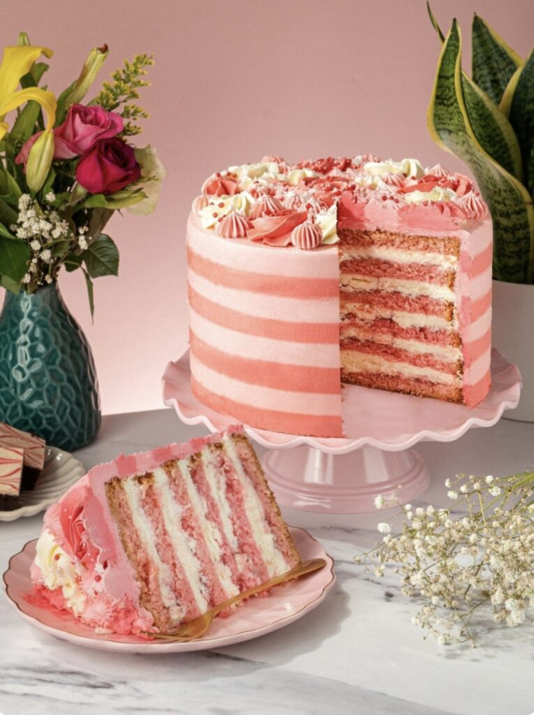 Pink Candy Stripe Gateau layered sponge with raspberry jam and cream, decorated with pink buttercream stripes and sugar pearls – a stunning 13th birthday cake idea.