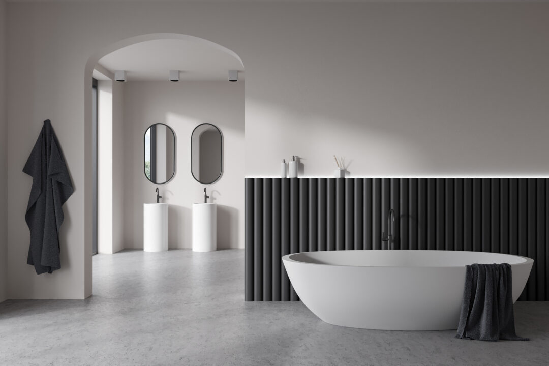 Modern black and white bathroom design with a freestanding bathtub, double vanity, arched mirrors, and minimalist decor.