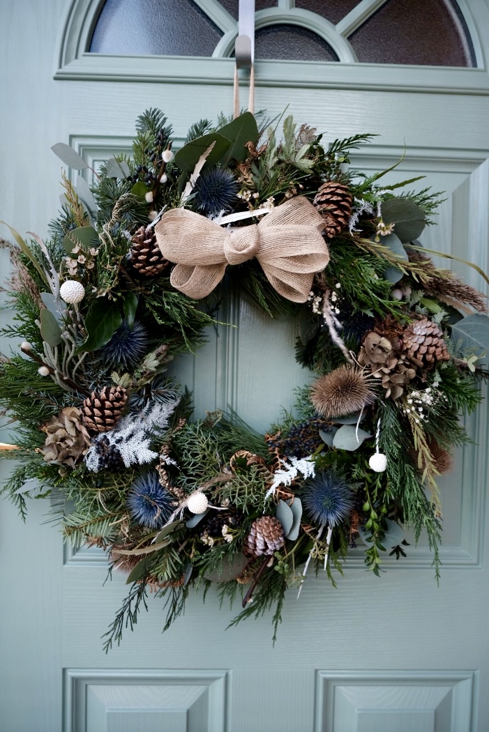 Artisan Luxury Christmas Wreath in deep greens with blue accents and a natural bow
