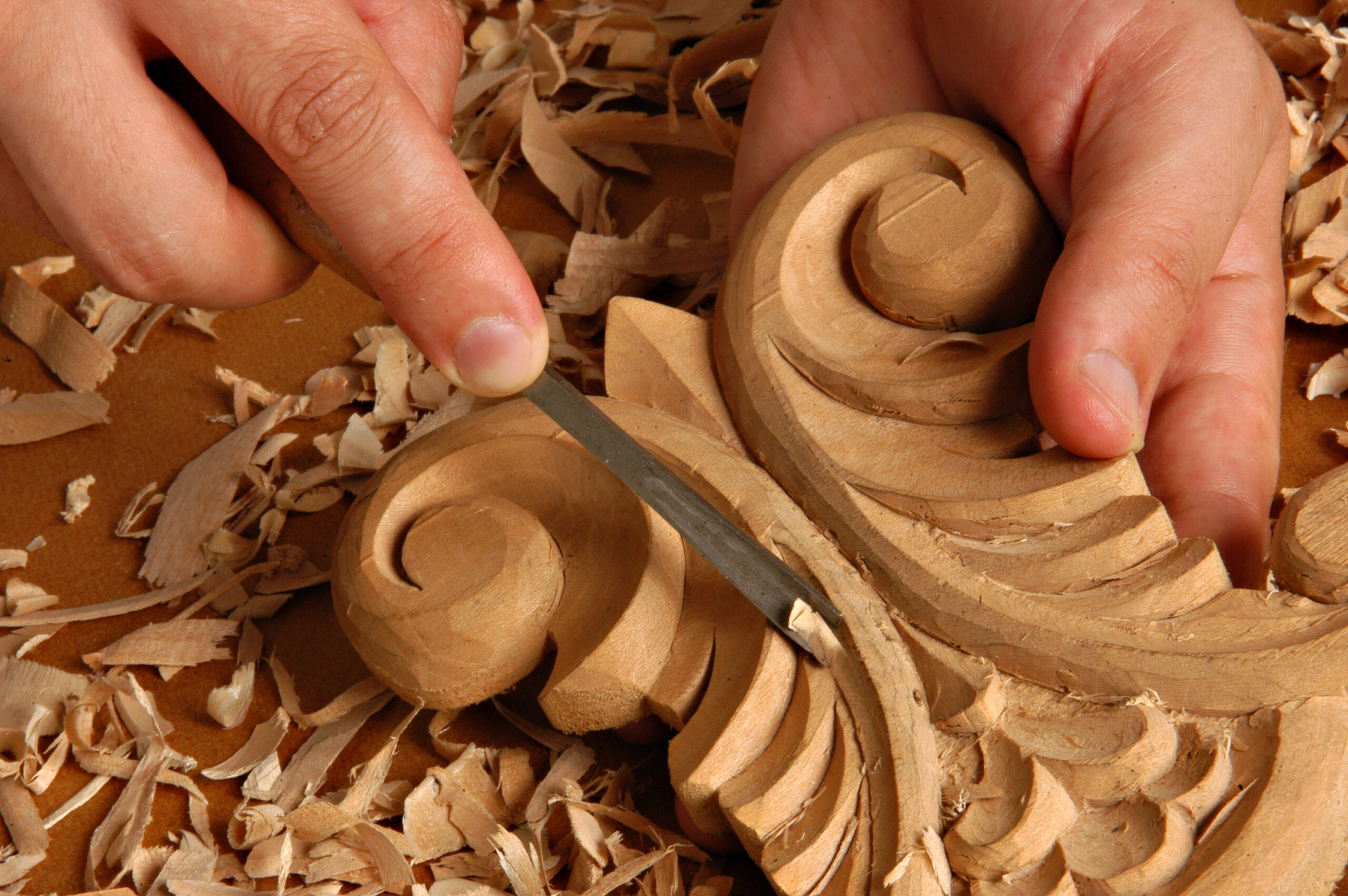 Two makers working together on pottery at the wheel.
