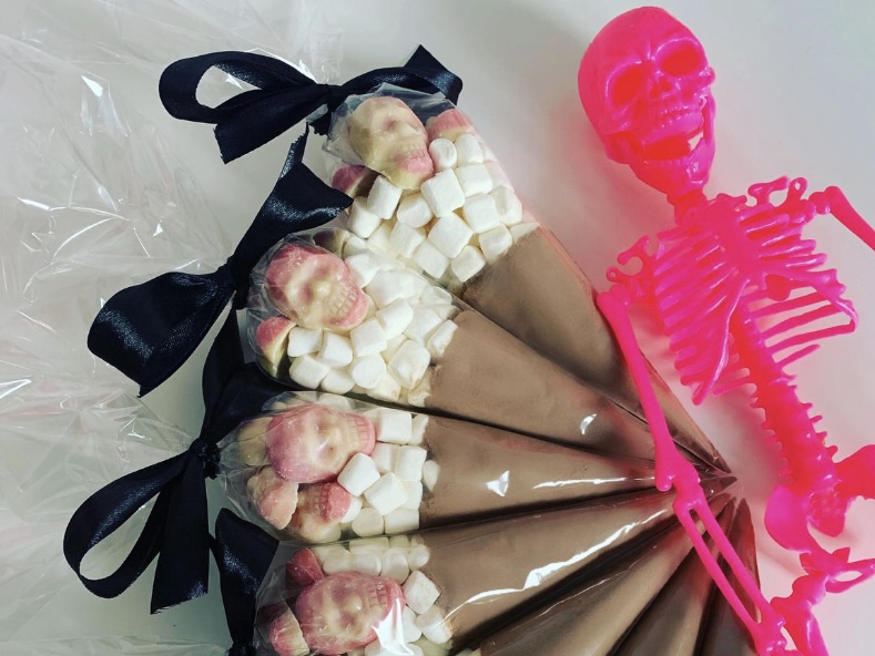 Halloween hot chocolate cones filled with chocolate powder and mini marshmallows