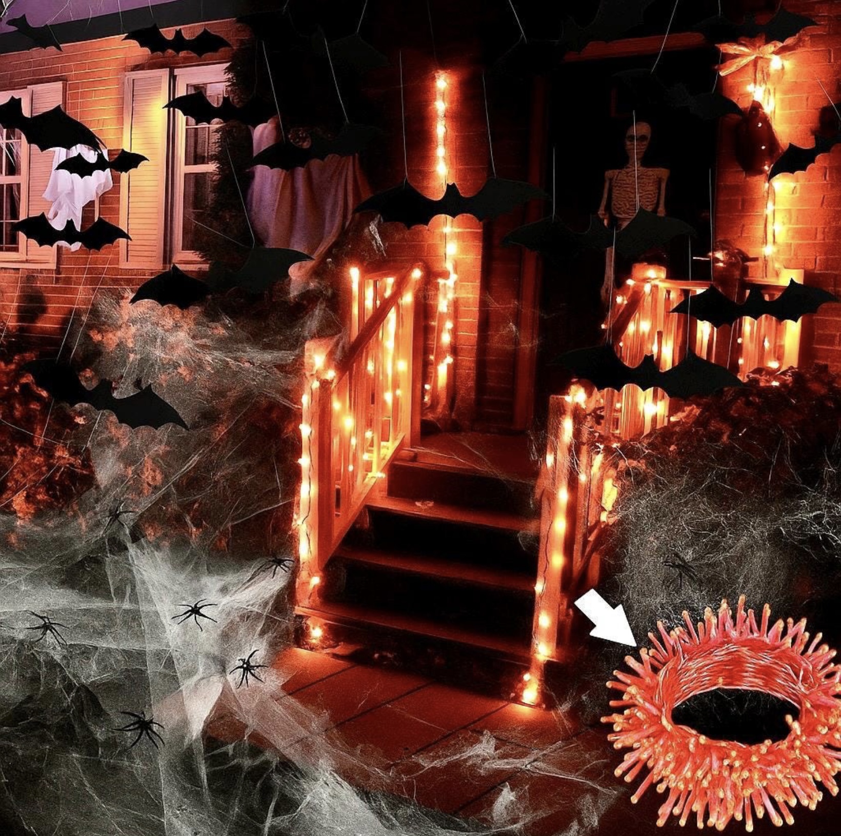 Front porch styled with orange LED lights, hanging bats and spider webs