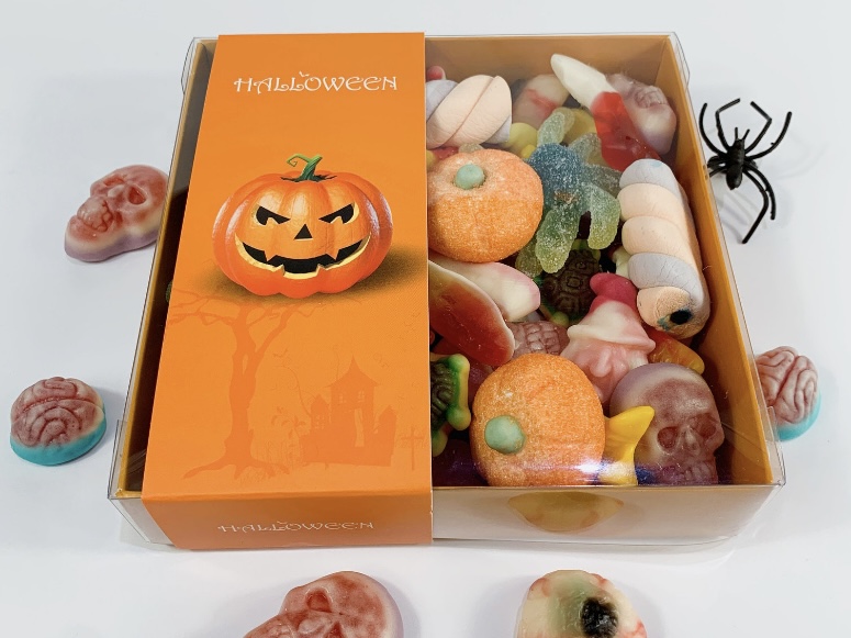 Halloween sweet box with gummy pumpkins, brains and eyeballs arranged in rows