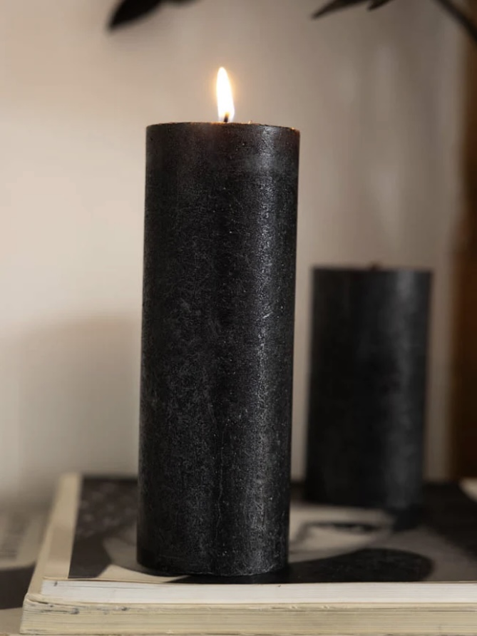 Large metallic anthracite shimmer pillar candle styled on books — on modern black console