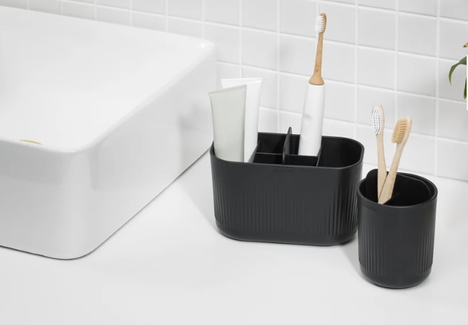 ReBorn recycled plastic bathroom caddy in matte black with divided compartments
