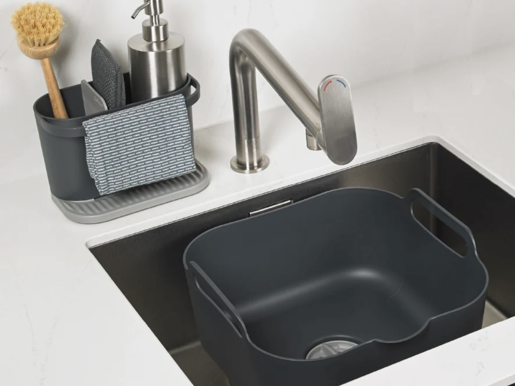 ReBorn recycled plastic washing-up bowl and sink tidy in grey on a white worktop