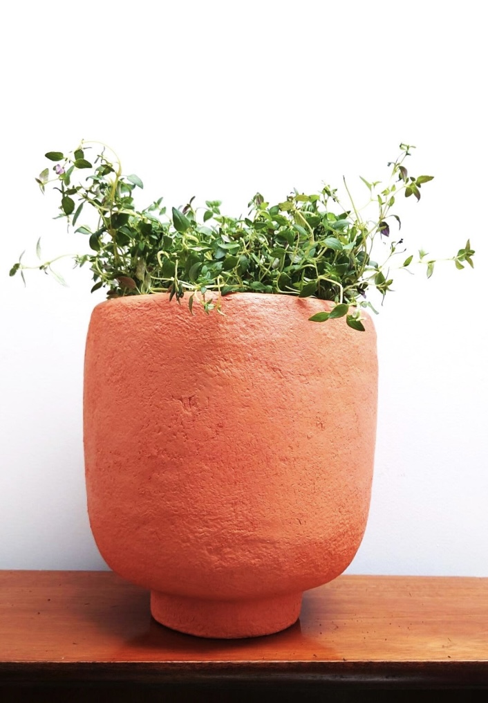 Sculptural recycled bottle-and-paper vase with terracotta tones