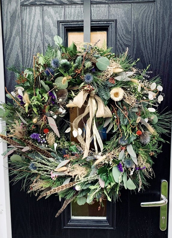 Showstopper Christmas Luxury Festive Wreath with fresh and dried elements and a ribbon bow on a black front door
