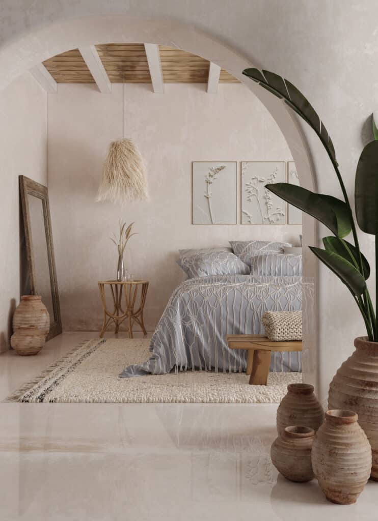 A calm base palette in action: warm white walls, sandy neutrals and rattan texture, grounded with soft grey bedding and natural pottery.