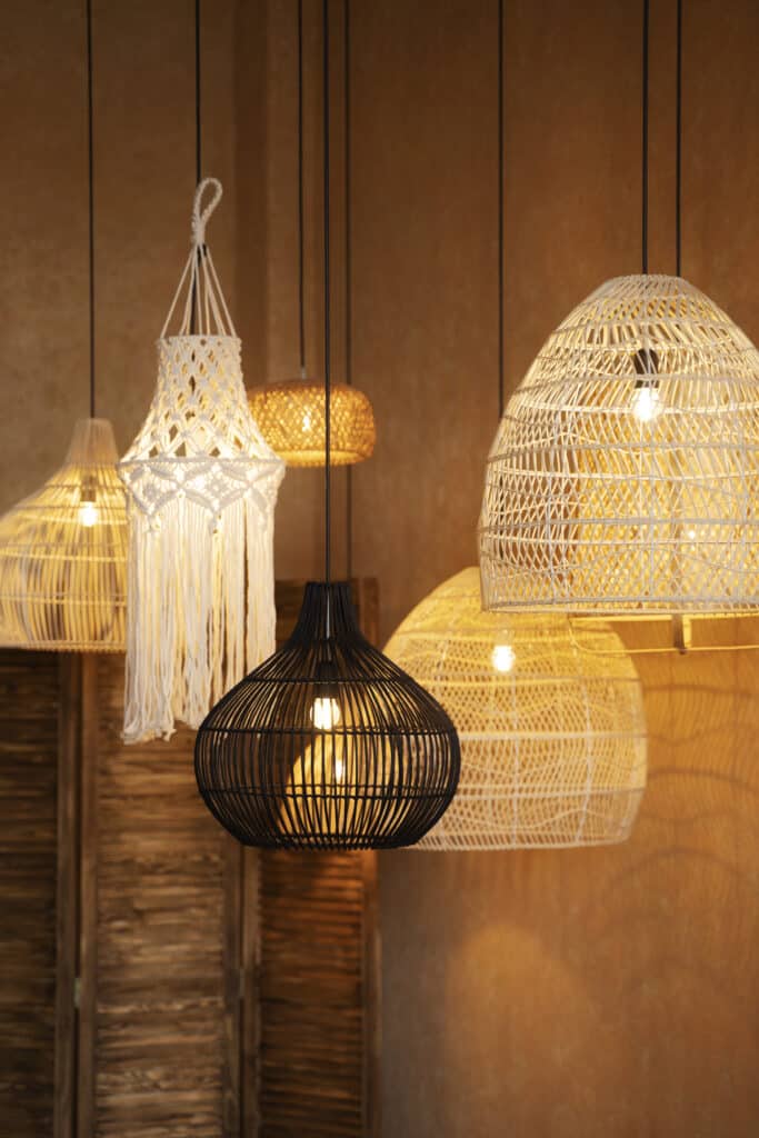 Layered boho bedroom lighting with woven pendant lampshades and warm bulbs creating a soft, cosy glow.