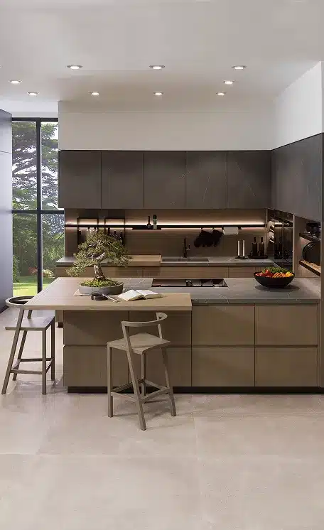 Modern handleless kitchen with dark stone-effect wall units, wood-grain base cabinets, under-shelf lighting and a timber breakfast bar