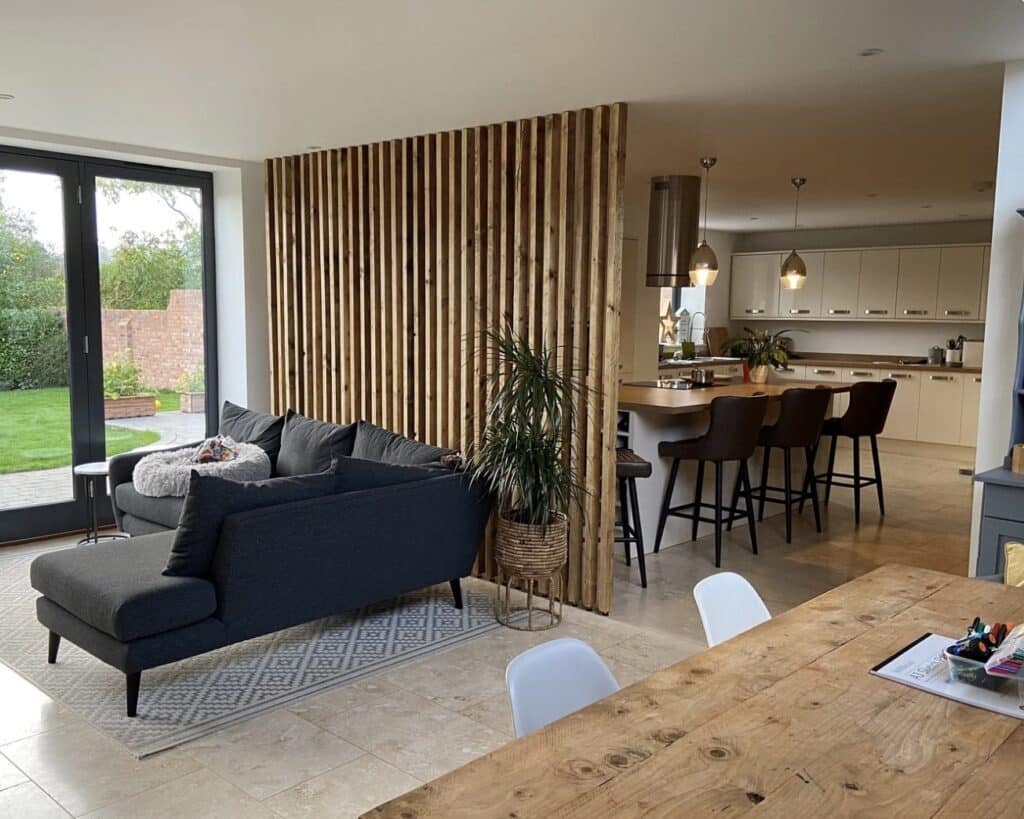 Living room divider ideas: RobertRoseCarpentry Georgina wooden wall partition dividing open plan kitchen and living room in a British home