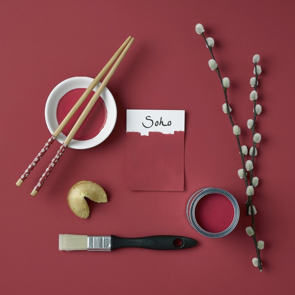 Rust-Oleum SoHo paint swatch with paintbrush, chopsticks and pussy willow stems on a burgundy background​​​​​​​​​​​​​​​​