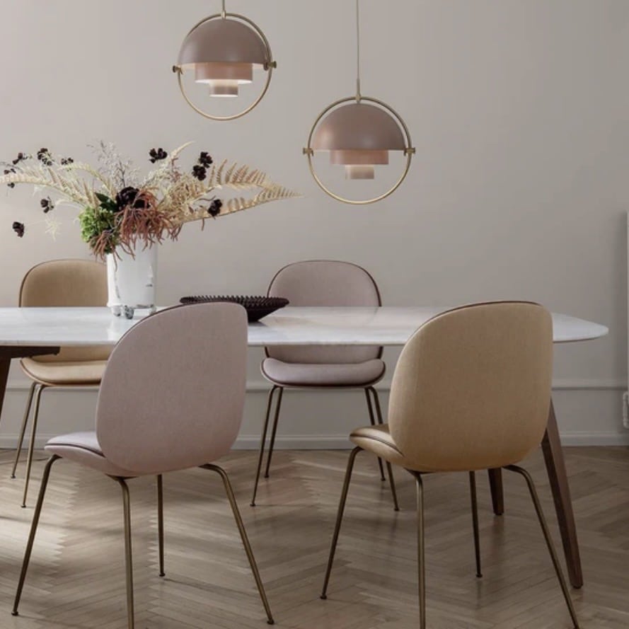 mid-century modern dining room lighting ideas with GUBI Multi-Lite pendant in blush and brass above round table
