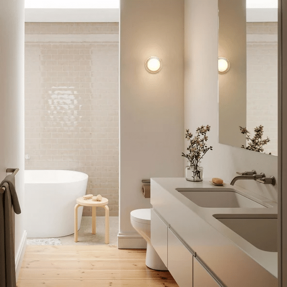 Tala Firth recessed wall light glowing softly beside a freestanding bath