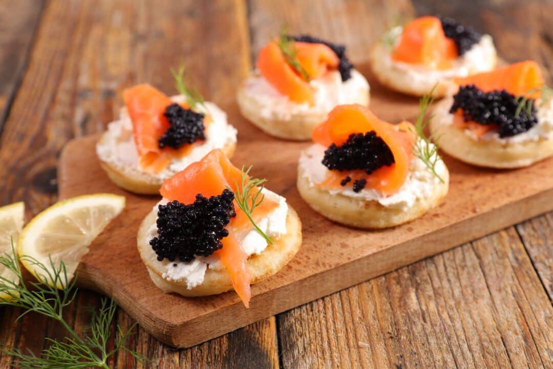 Caviar served on ice with blinis and classic garnishes