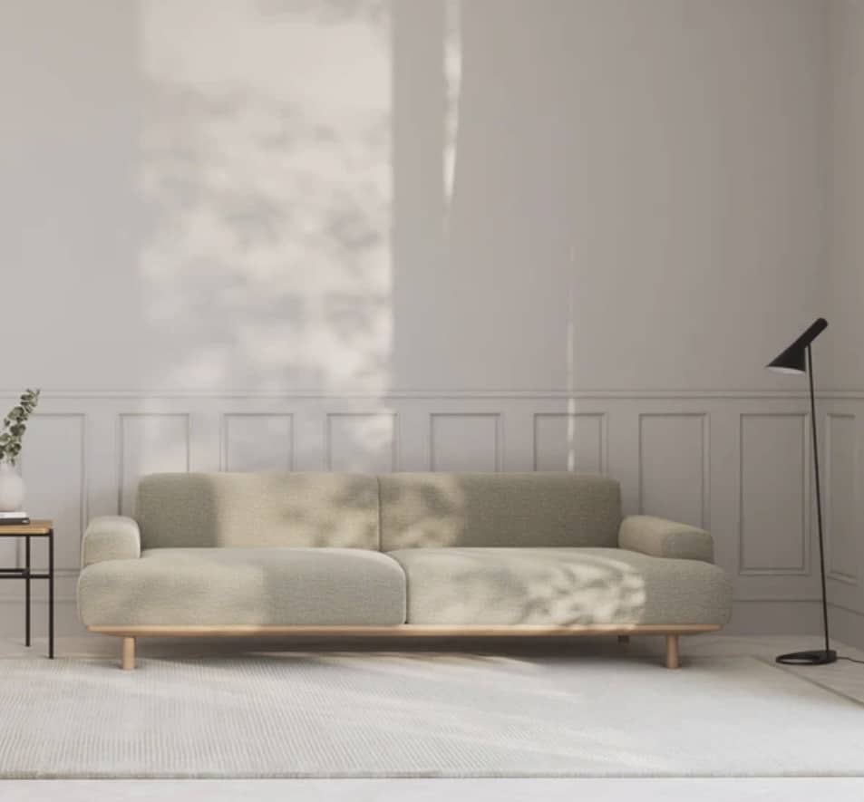 Beige-toned living room featuring a generously sized light rug extending beneath a cream two-seater sofa