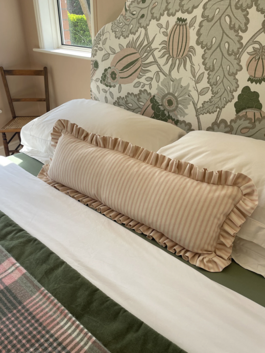 green and pink bedroom in an eclectic style mixing patterns, florals, stripes and plaids