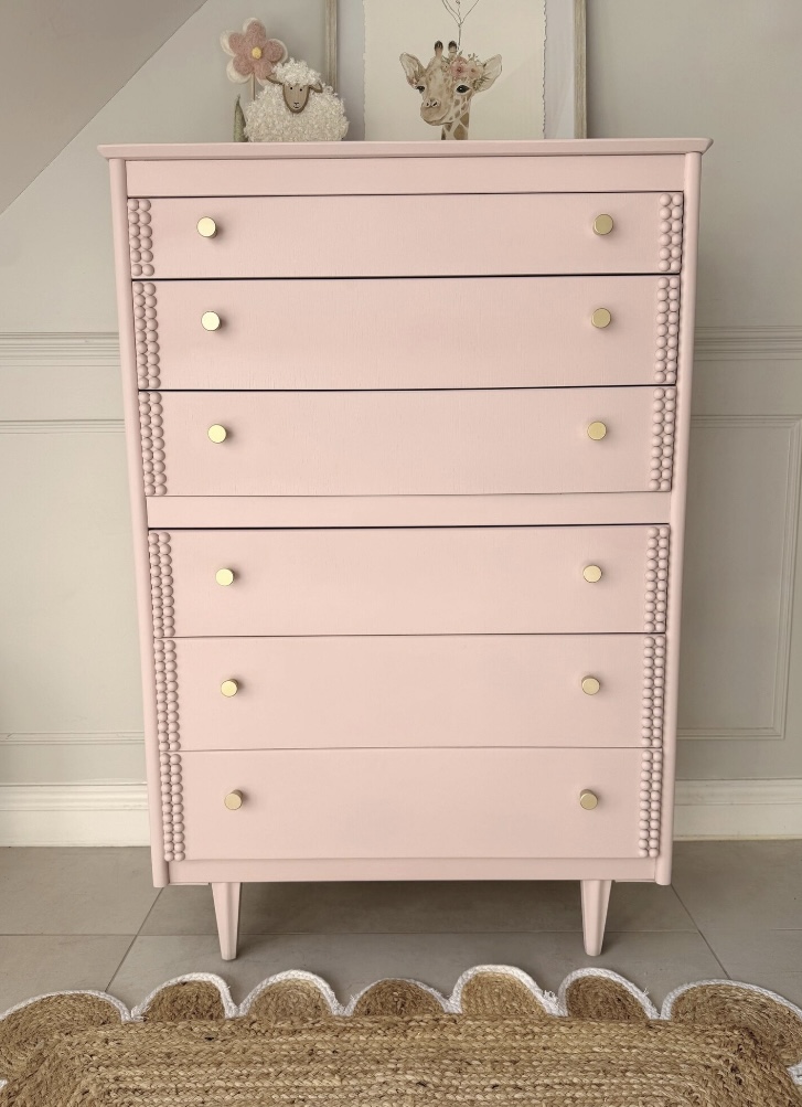 Vintage pink chest of drawers with bobbin trim, perfect for pink and green bedroom decor