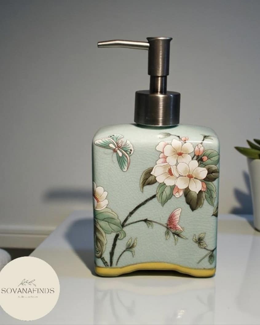 Ceramic floral hand soap dispenser in soft green with blossom motif