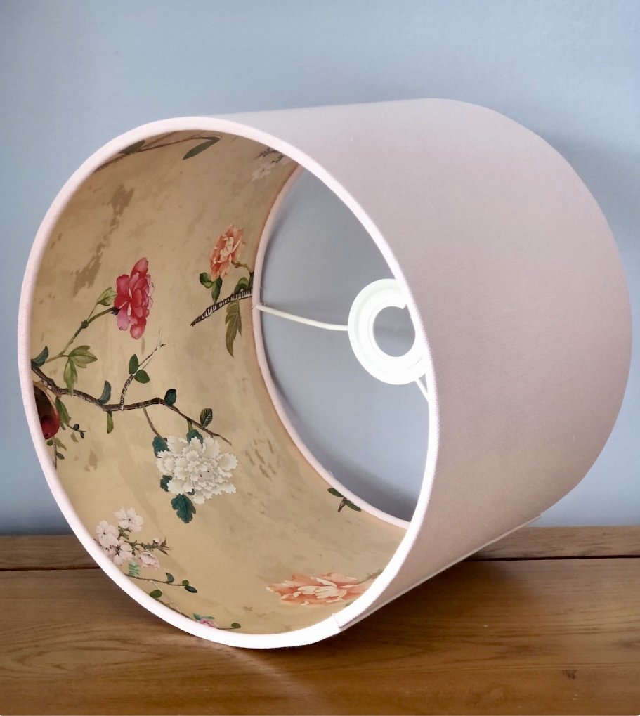 Light pink lampshade with floral lining would suit an elegant pink and green bedroom