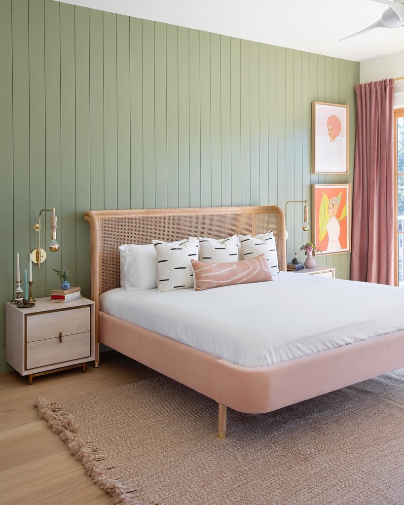 Pink and green bedroom with Farrow & Ball Lichen tongue-and-groove panelling, a blush velvet bed with cane headboard and dusky pink velvet curtains