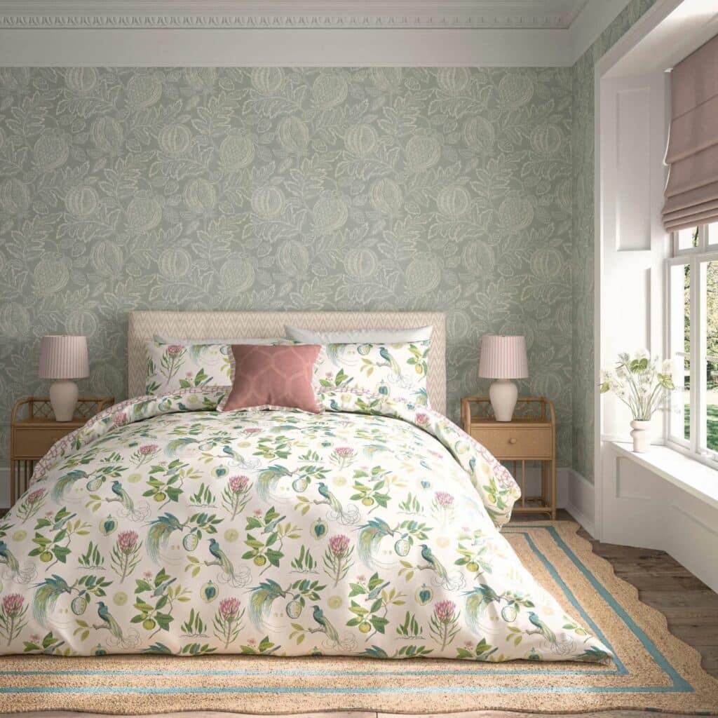 pink and green bedroom with botanical bedding and sage wallpaper