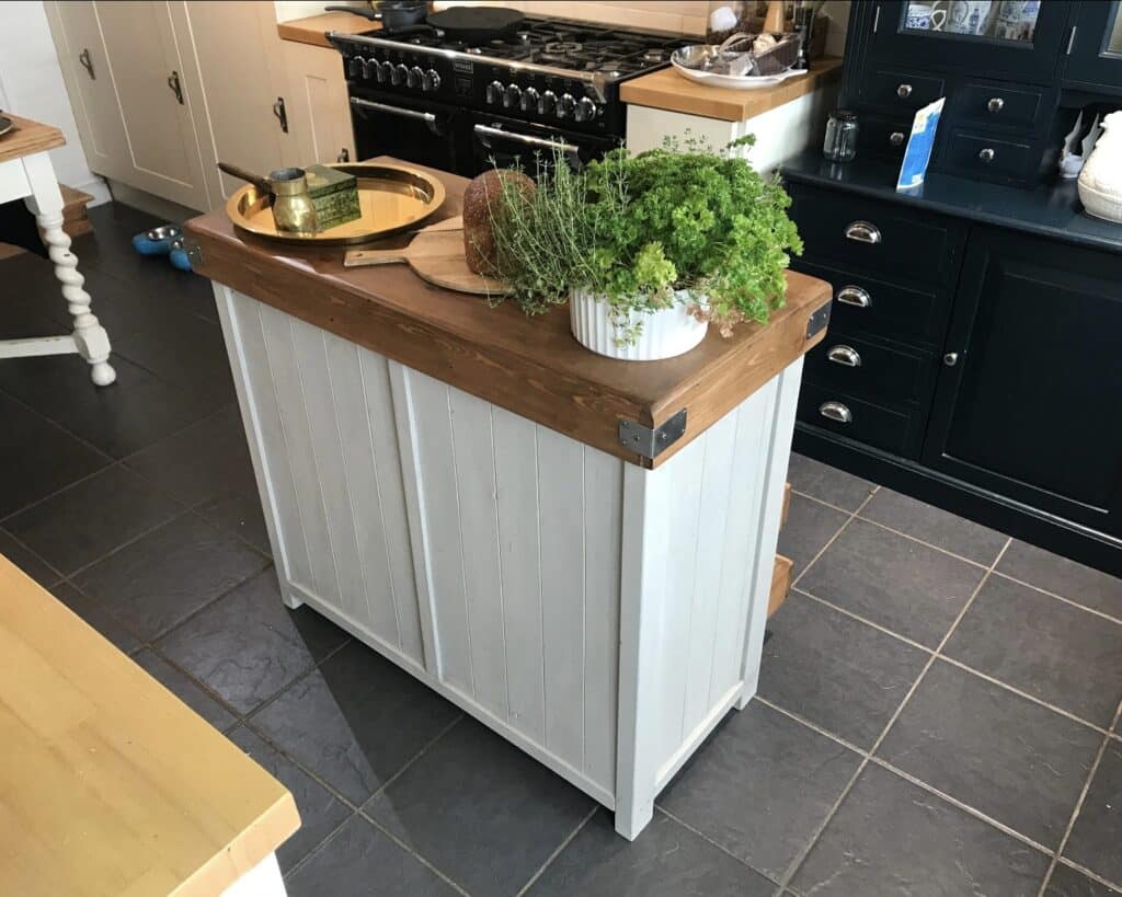 small handcrafted butchers block kitchen island in a dark kitchen