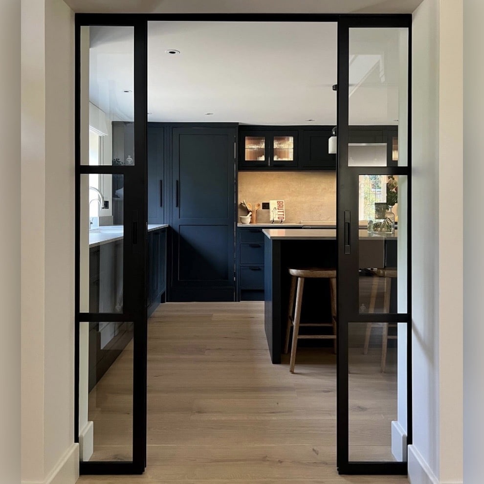black scandi kitchen seen through crittall glass doors