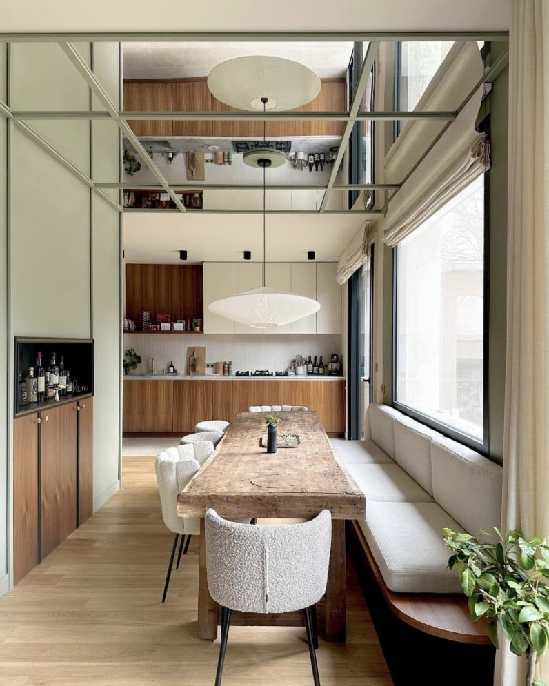 scandi boho kitchen with sage green walls and walnut cabinetry