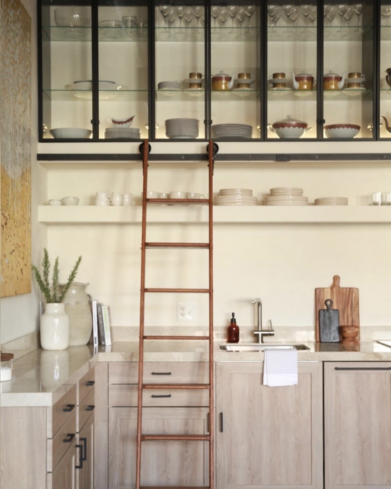 industrial scandi kitchen with ladder and glass-fronted cabinetry