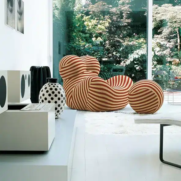 B&B Italia Serie Up 2000 striped accent chair in beige and orange beside large windows with garden view