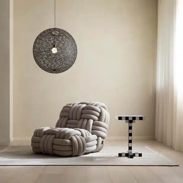 Moooi Knitty knotted rope lounge chair in neutral room with oversized pendant lighting