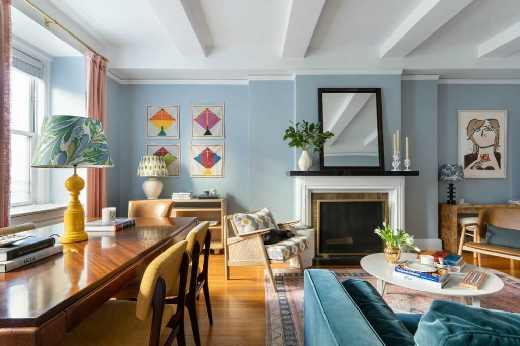 Light blue living room with ikat accent chair, kite print wall art and yellow lamp