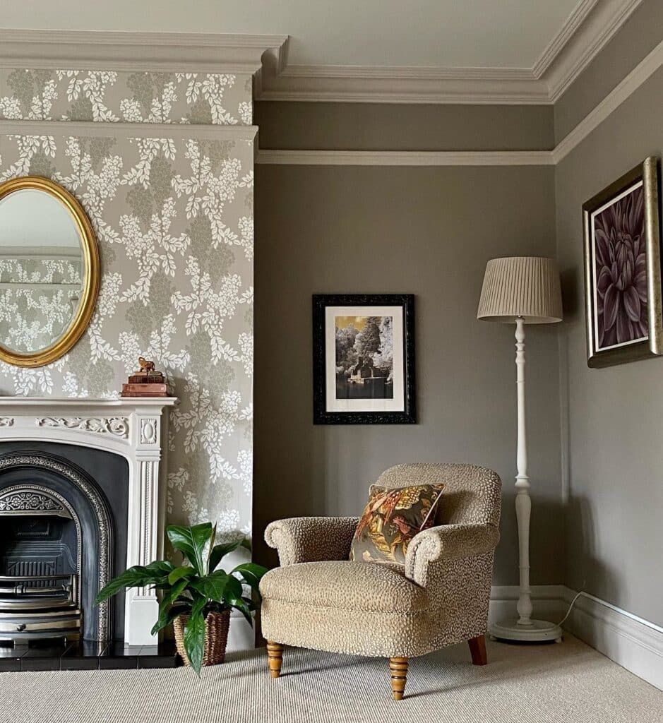 Cream boucle accent chair beside a fireplace in a Charleston Gray living room with Wisteria wallpaper and botanical cushion