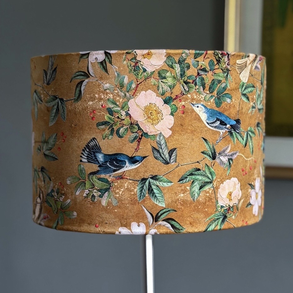 Chinoiserie velvet lampshade with birds and blossom in warm gold tones