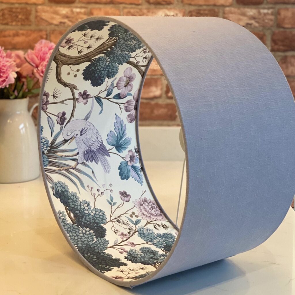Pale blue linen lampshade lined with chinoiserie crane and floral paper