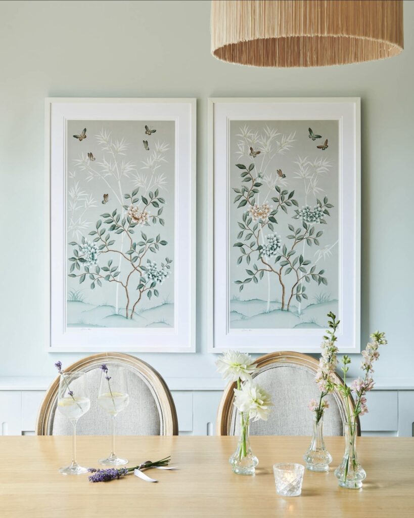 Framed pastel chinoiserie wall art pair with butterflies and bamboo above a dining table