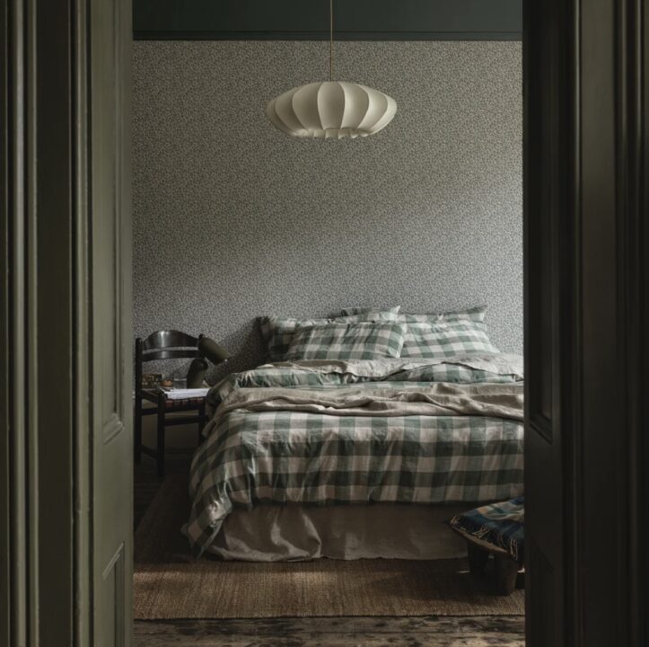 Beige green bedroom design, with sage green painted doors, green checked linen bedding and green and beige wallpaper