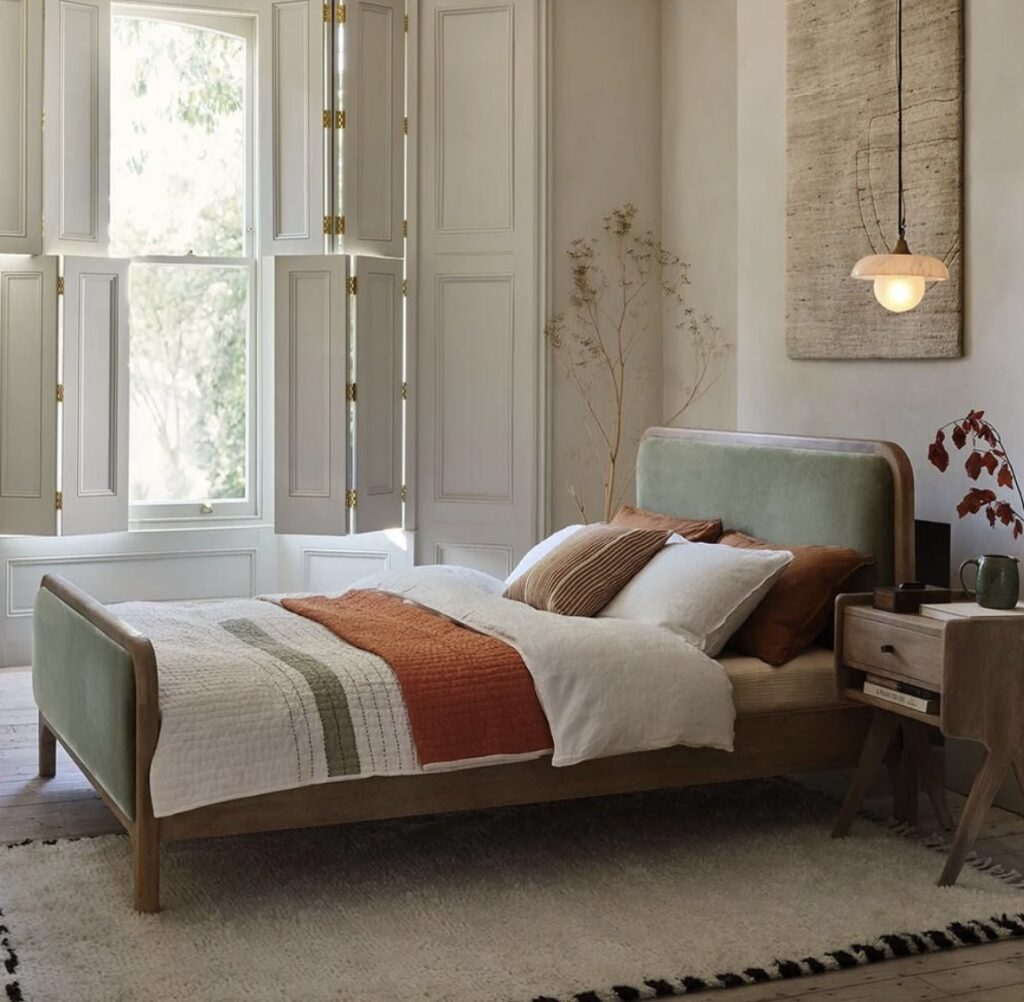 Subtle green and beige bedroom, with terracotta and wooden accents creating an organic feel 