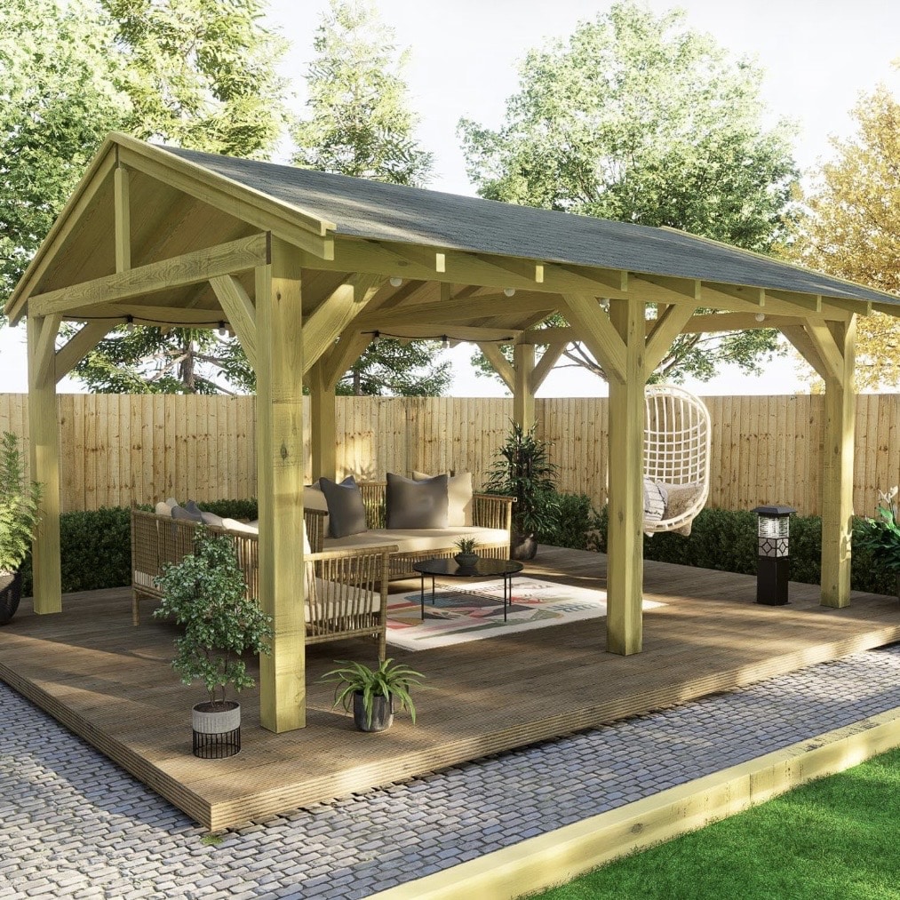 Freestanding wooden gazebo with felt shingle roof and rattan garden furniture