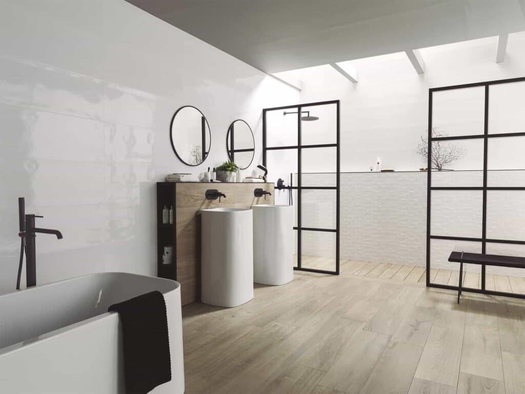 Large black and white bathroom with Porcelanosa Manhattan Colonial wood-effect floor tile, crittall shower screen, freestanding bath and pedestal basins