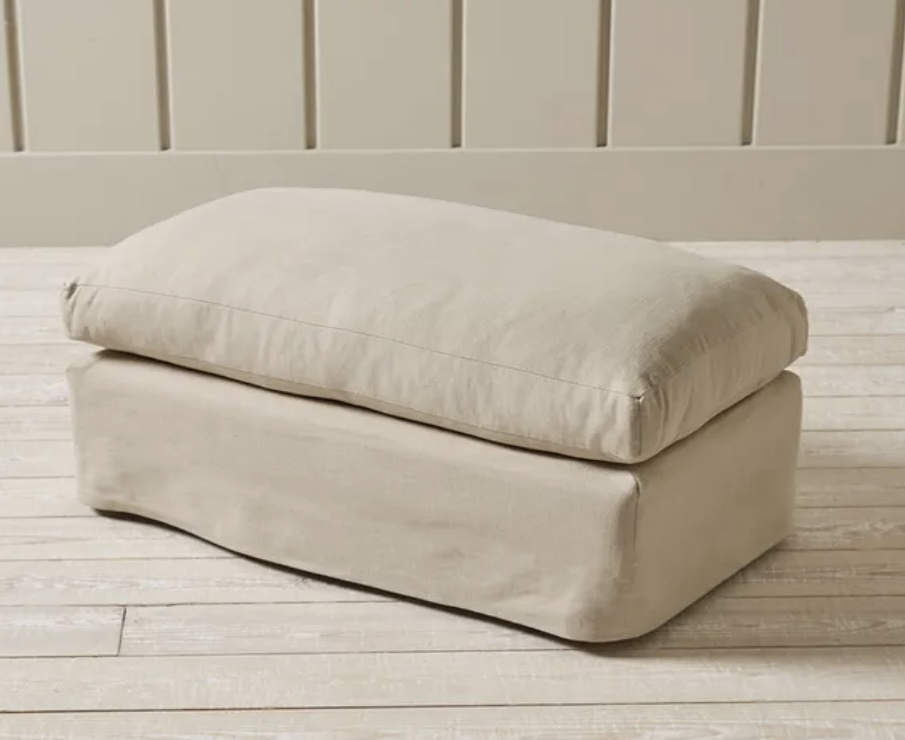 Colmar ottoman in oat linen cotton blend placed at the foot of the bed, adding soft texture and function to beige bedroom decor.