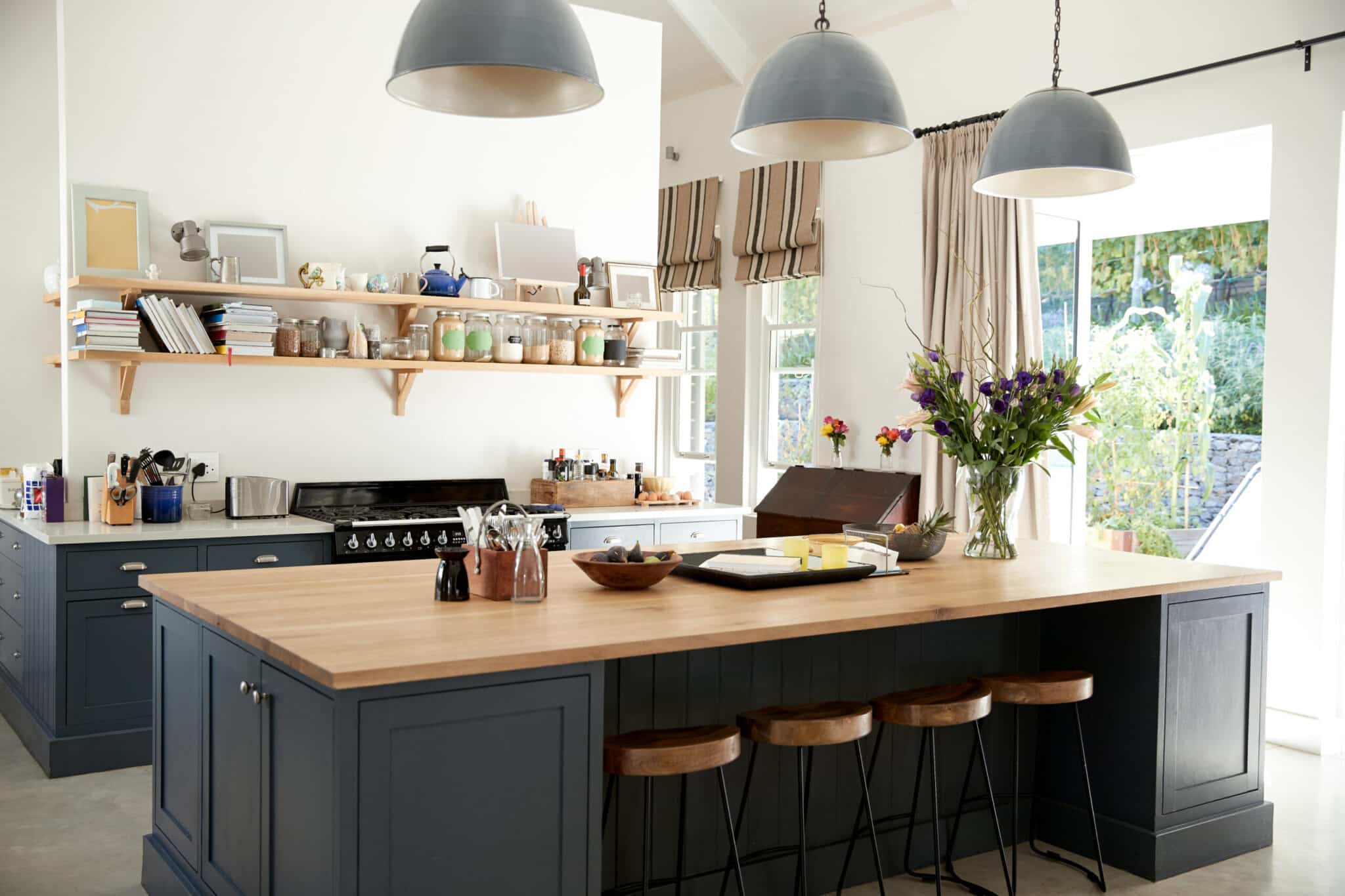 Blue kitchen cabinets with warm neutral tones