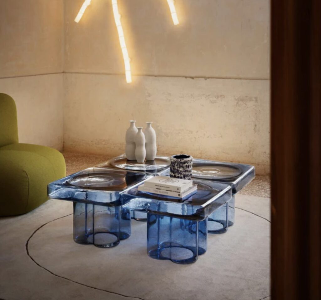 Four blue Miniforms Soda Square glass coffee tables arranged together as a sculptural centrepiece in a modern living room.