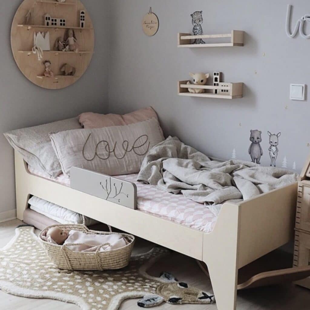 Girls bedroom with Swedish Linens Rainbows Nudy Pink fitted sheet, grey walls and wooden shelf displays — girls bedroom bedding ideas