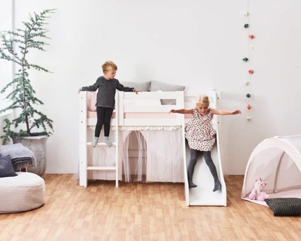 Hoppekids Eco Luxury mid sleeper bed with slide and pink tulle curtain — girls bedroom ideas