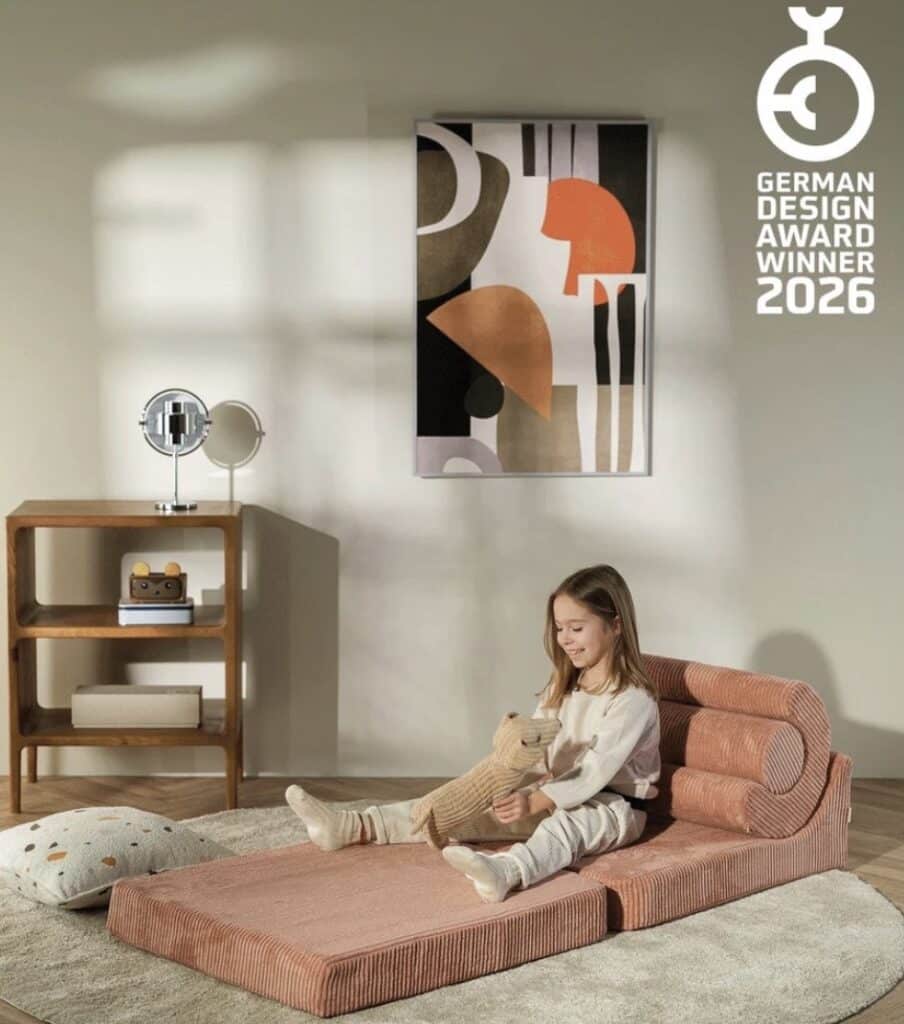 Girl relaxing on Wigiwama Flipster Chair unfolded as lounger in bedroom — girls bedroom seating ideas