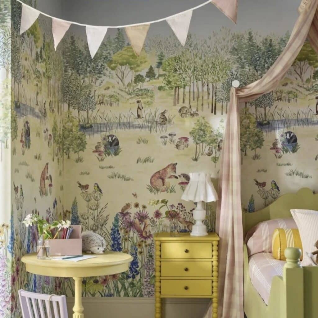 Little girls bedroom with Little Greene Potter’s Woodland mural wallpaper, yellow desk and bedside table and pink canopy — girls bedroom wallpaper ideas
