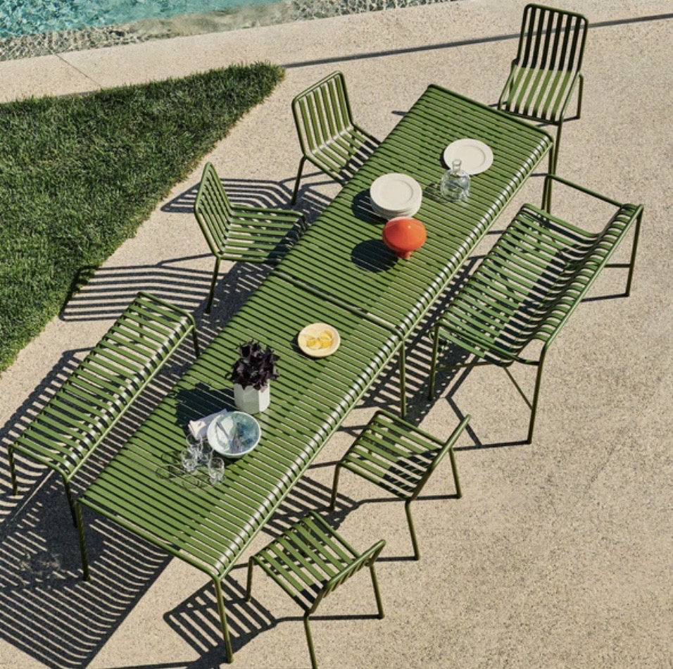 HAY Palissade extra large olive green metal outdoor dining table with chairs beside a pool